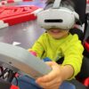 mmexport1736150371034 VR headset for kids at entertainment center, immersive virtual reality gaming experience for children, modern VR technology for entertainment and education.