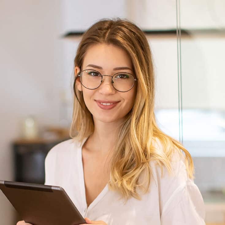 young-woman-working-with-digital-tablet-in-the-off-7FHM3FZ-e1756718259900