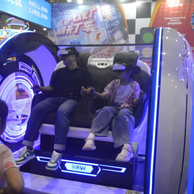 Futuristic virtual reality amusement ride with kids using VR headsets, immersive gaming experience at an expo or tech event, illuminated with vibrant LED lights and high-tech design.