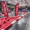 Indoor MR GO KART racing track with red barriers and flags at a shopping mall. Indoor MR GO KART racing track with red barriers and flags at a shopping mall. Perfect for family entertainment and fun racing experiences.