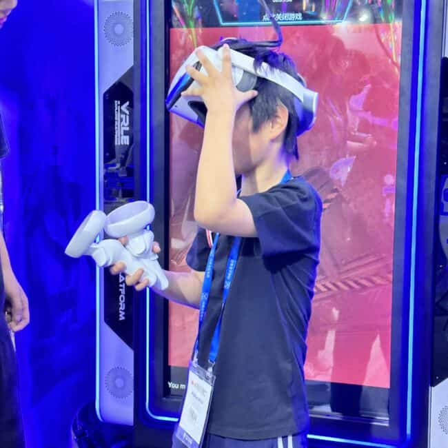 VR gaming enthusiast enjoying an immersive experience with a virtual reality headset and controllers at an arcade. The vibrant neon-lit environment enhances the virtual gaming atmosphere.
