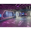 Brightly lit indoor tech space with neon LED accents and digital graphics on floors and walls, perfect for gaming, virtual experiences, or high-tech events.