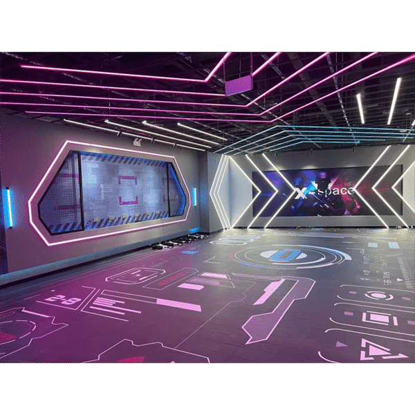 Brightly lit indoor tech space with neon LED accents and digital graphics on floors and walls, perfect for gaming, virtual experiences, or high-tech events.