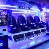 High-tech VR gaming experience with multiple seats, immersive screens, and advanced virtual reality equipment for entertainment and gaming enthusiasts.