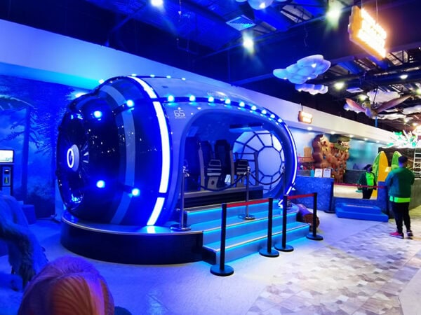 Imaginative indoor amusement park featuring a sci-fi capsule ride, colorful visuals, and engaging activities for children and visitors.