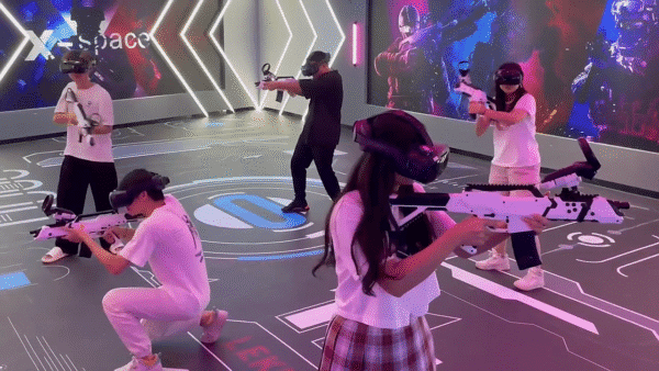 Kids and teenagers enjoying virtual reality shooting game at Lekevr Export VR zone, engaging in immersive digital entertainment in a high-tech environment.