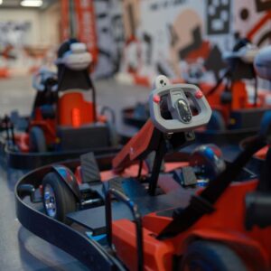Close-up of professional go-kart racing cars with digital dashboards on a race track.