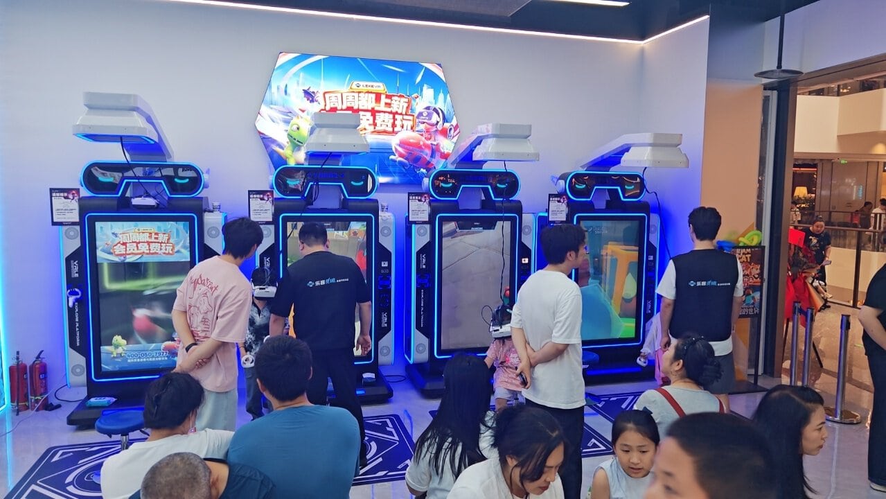 Virtual Reality Examples: Inside LEKE VR's New 1,000㎡ Flagship at Shanghai PRISMA Center 5 LEKE VR Shanghai store VR cinema zone with Space Shuttle 2.0 9D simulator and self-service VR stand stations, family guests and solo players visible